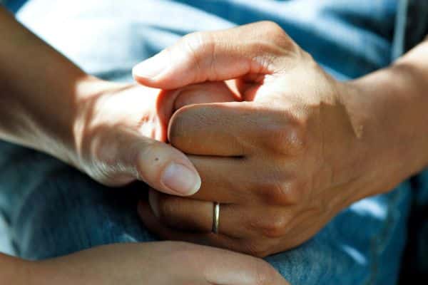 community-care-access A close-up of a carer holding patient's hand - representing the community care sector